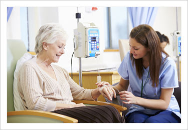 This is a picture of a nurse holding a iv line of a elderly patient.